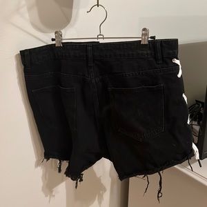 black jean shorts with shoe laces on the side